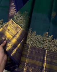 Sharvitha – Green and Navy Kanyaaram Silk Saree with Heavy Golden Zari Border and Floral Pallu